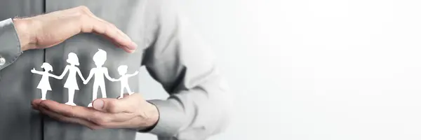 Man Holding Paper Family Close To His Heart - Family Care And Protection Concept