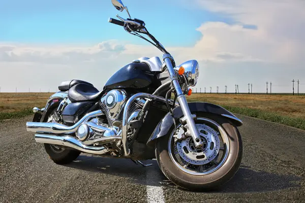 powerful black motorcycle on highway in country